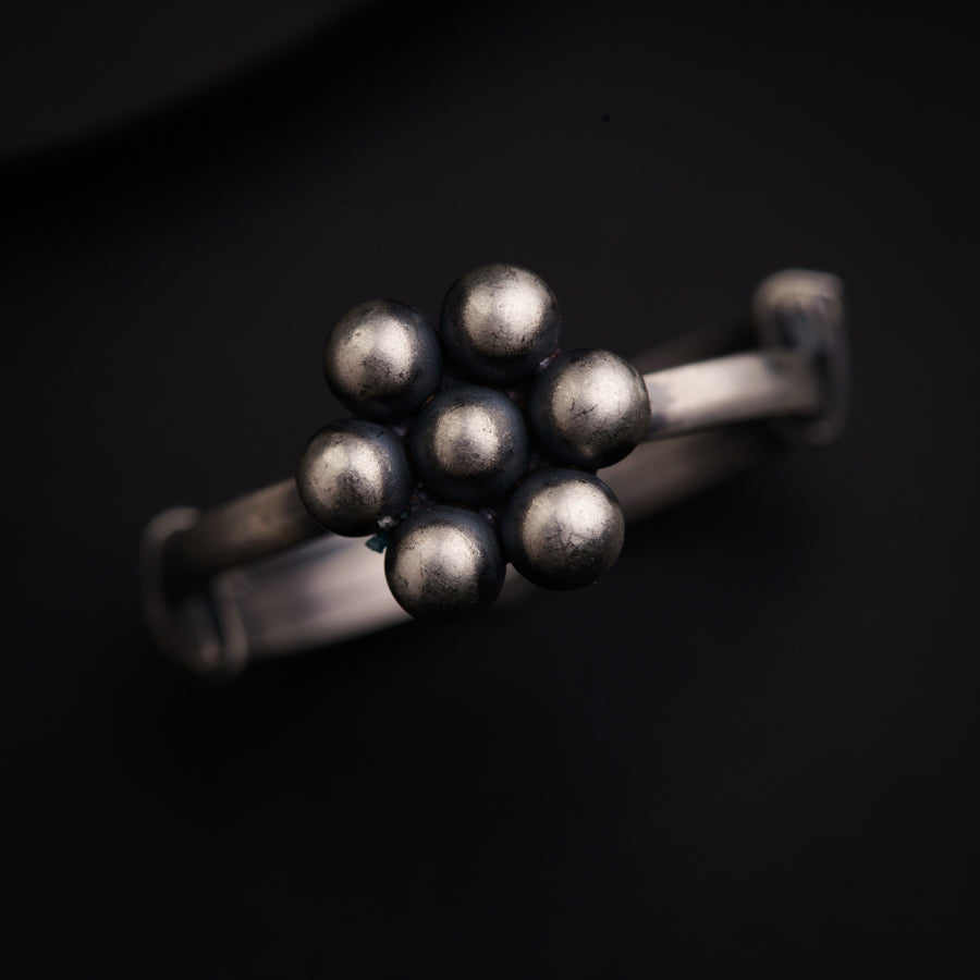 a close up of a metal object on a black surface