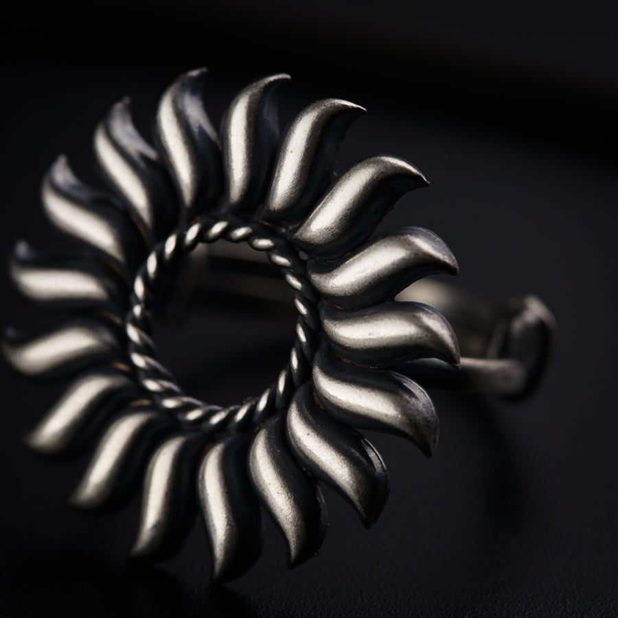 a silver ring with a spiral design on it