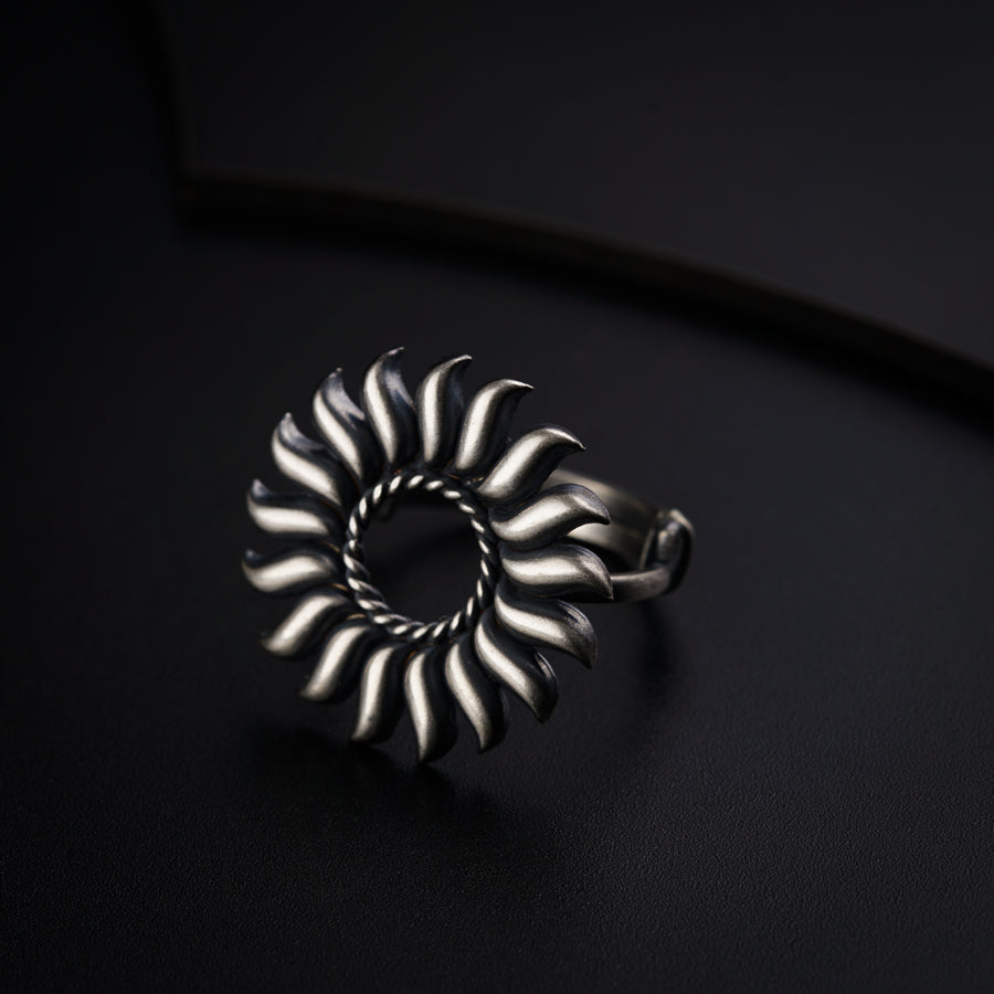 a silver ring sitting on top of a black surface