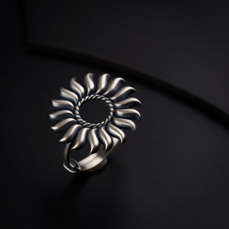 a silver ring sitting on top of a black surface