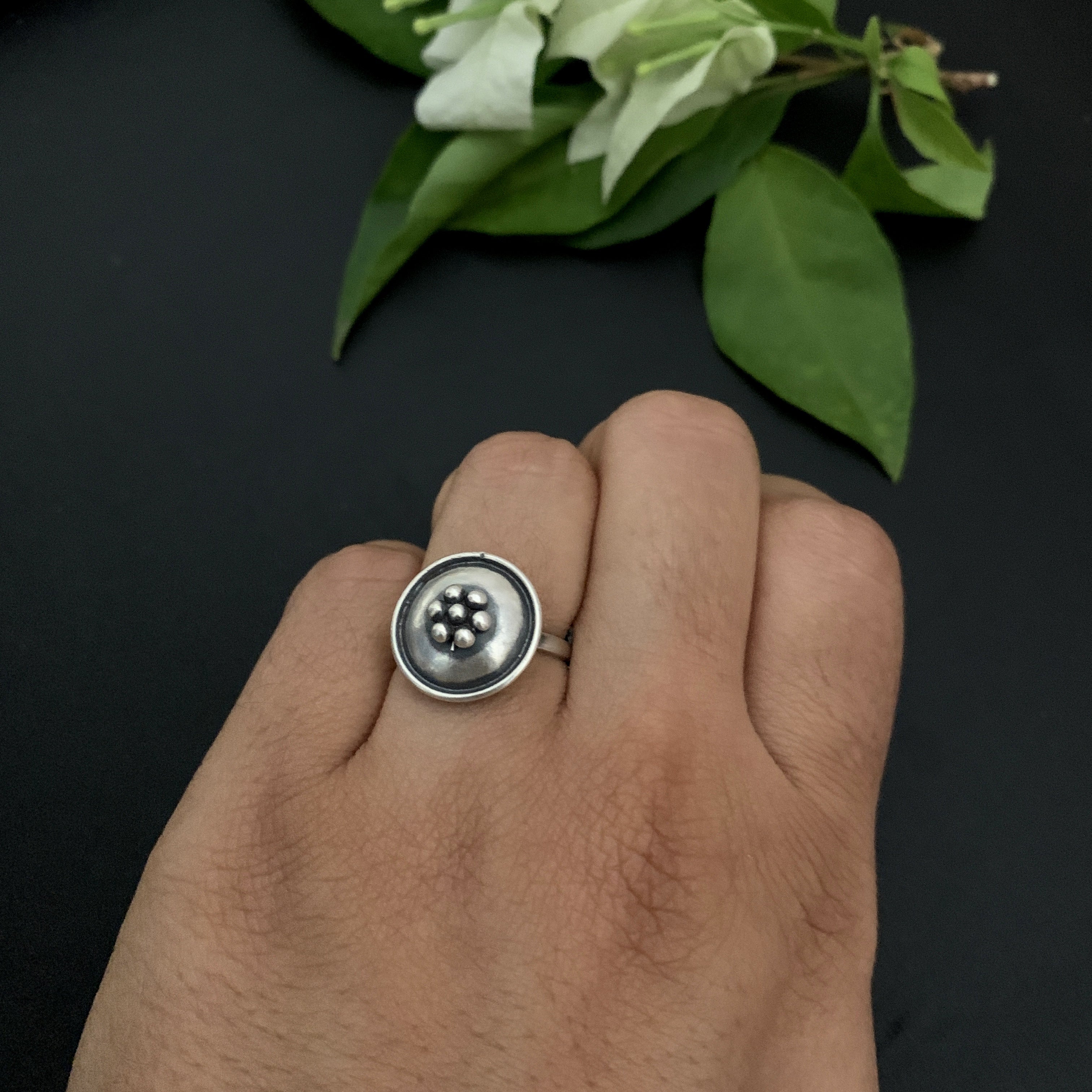 a person wearing a ring with a button on it