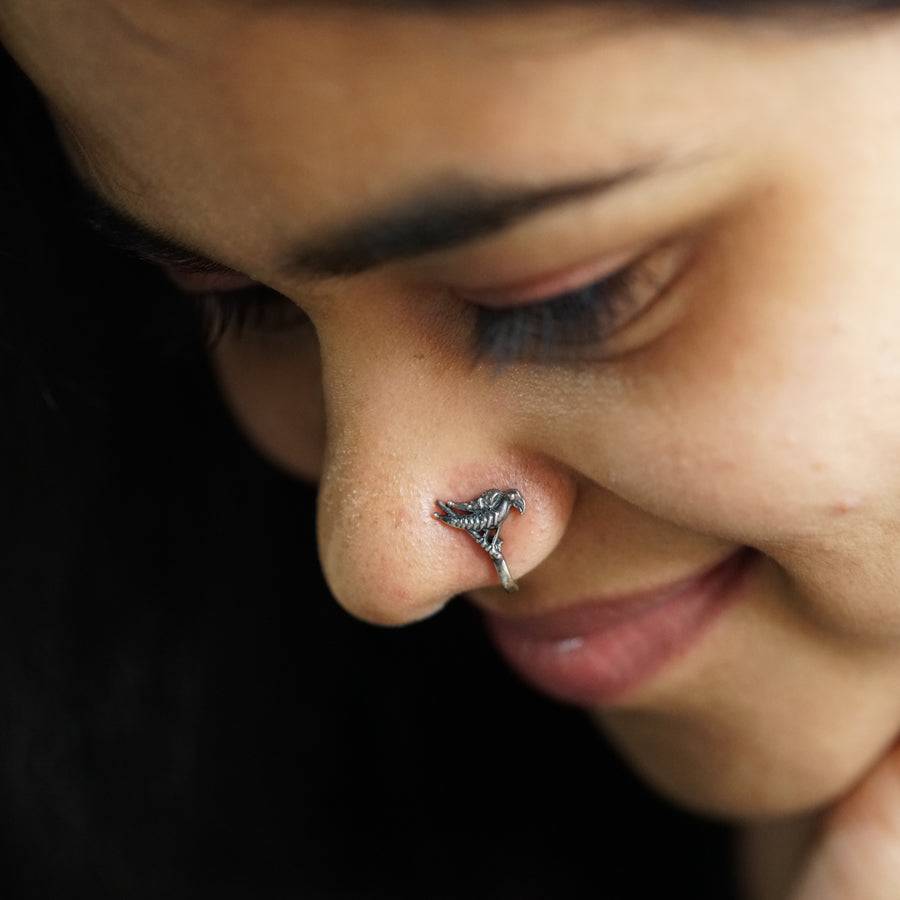 a close up of a person with a nose piercing