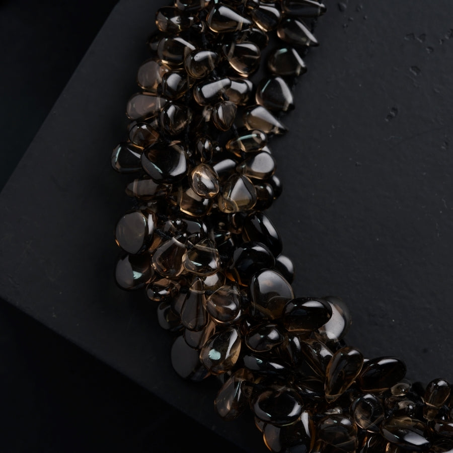 a bunch of brown and black stones on a black surface