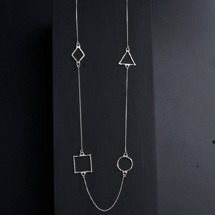 a silver necklace with a square, square, and triangle design on it