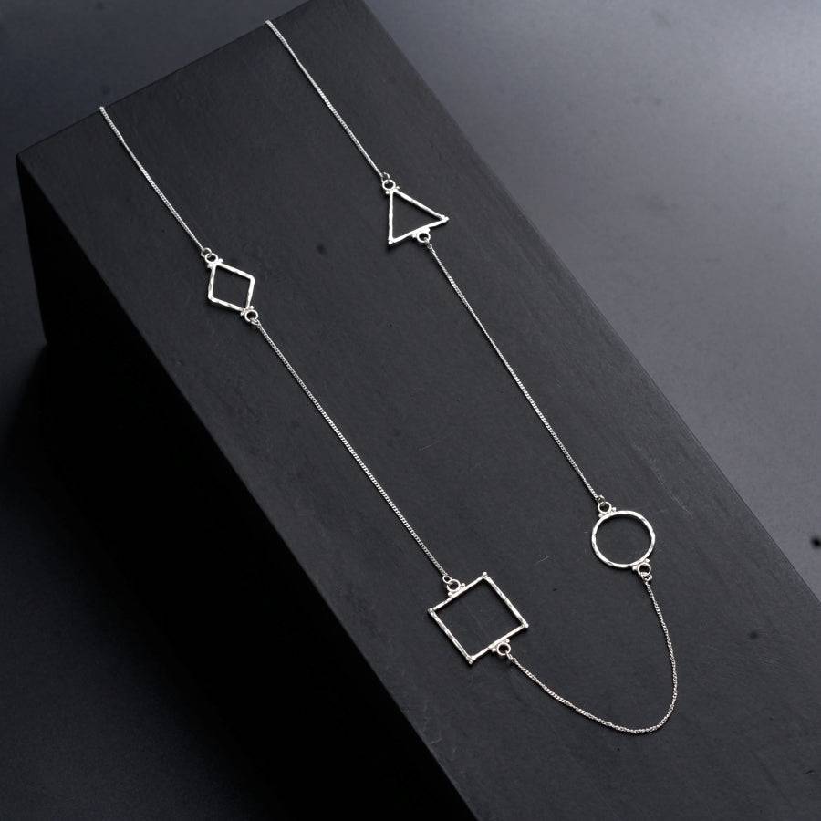 a pair of necklaces sitting on top of a wooden box