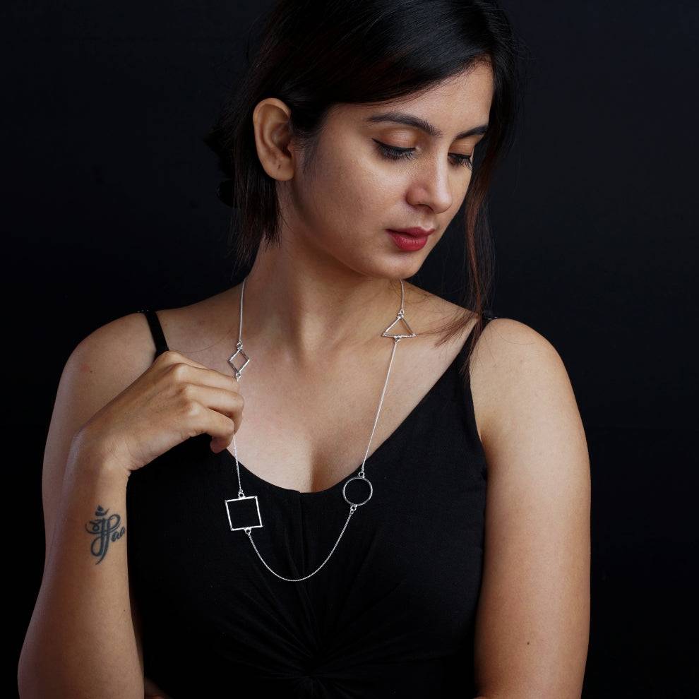 a woman wearing a black shirt and a silver necklace