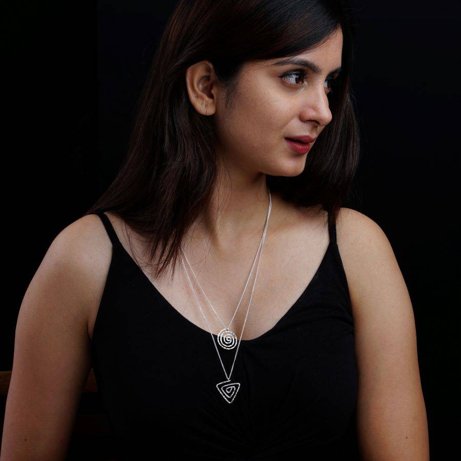 a woman wearing a black shirt and a silver necklace