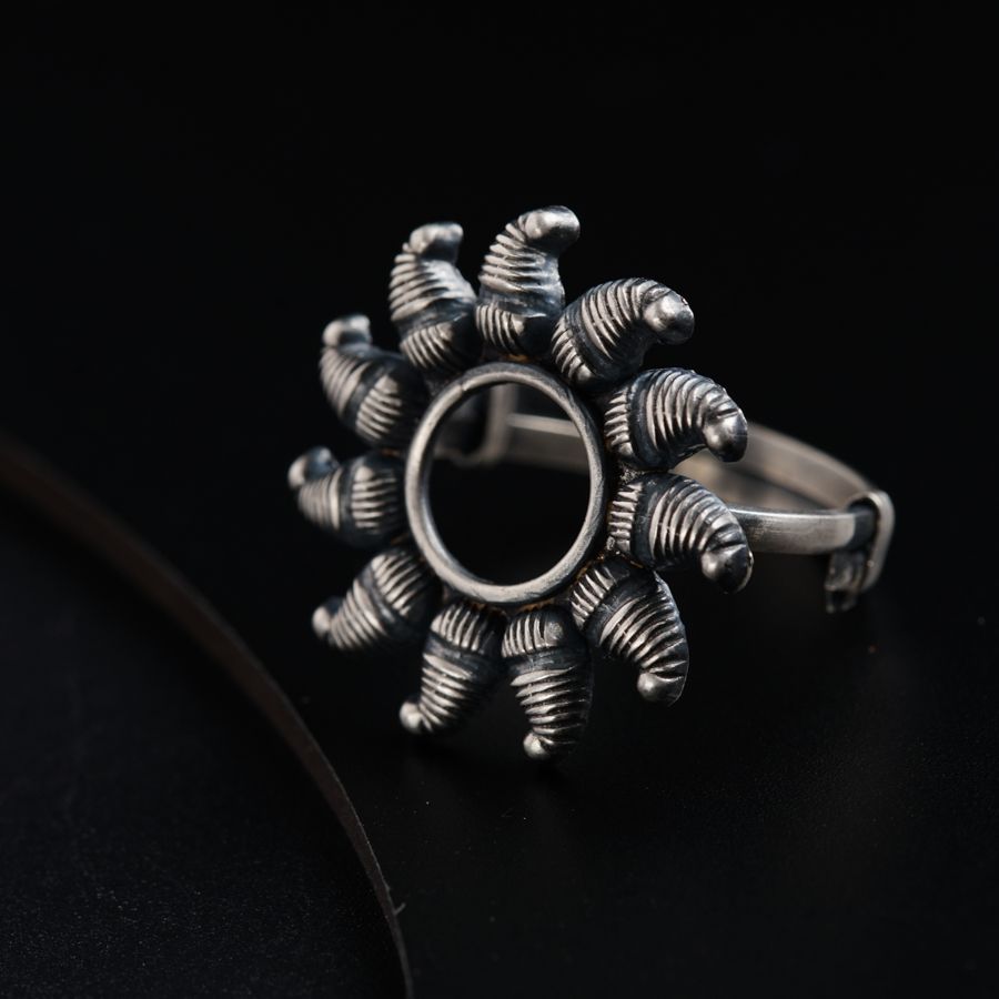 a silver ring sitting on top of a black surface