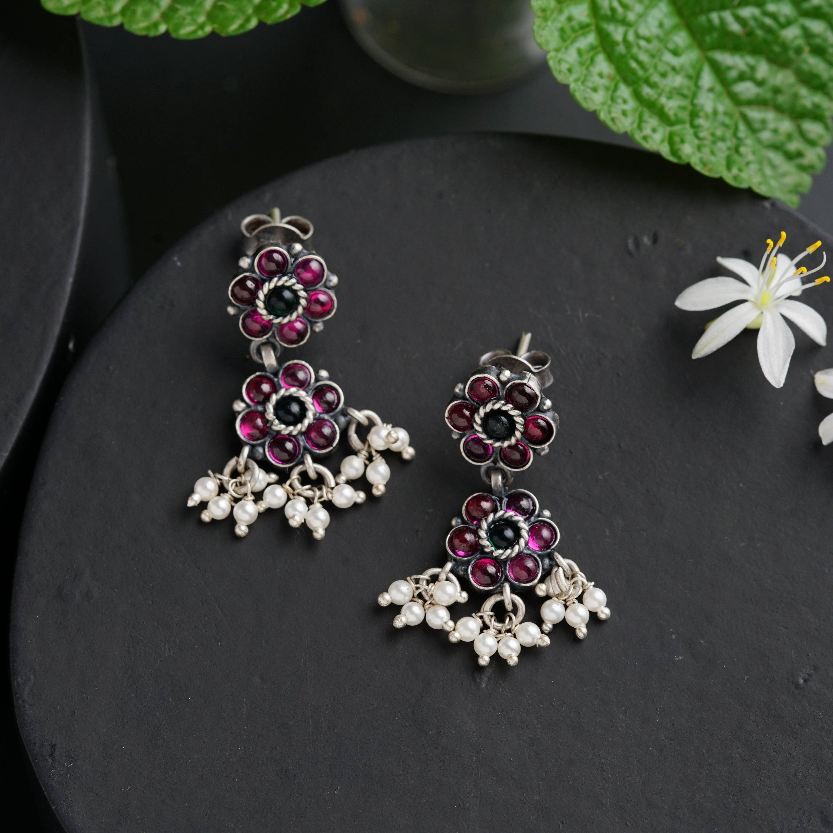 a pair of earrings sitting on top of a table