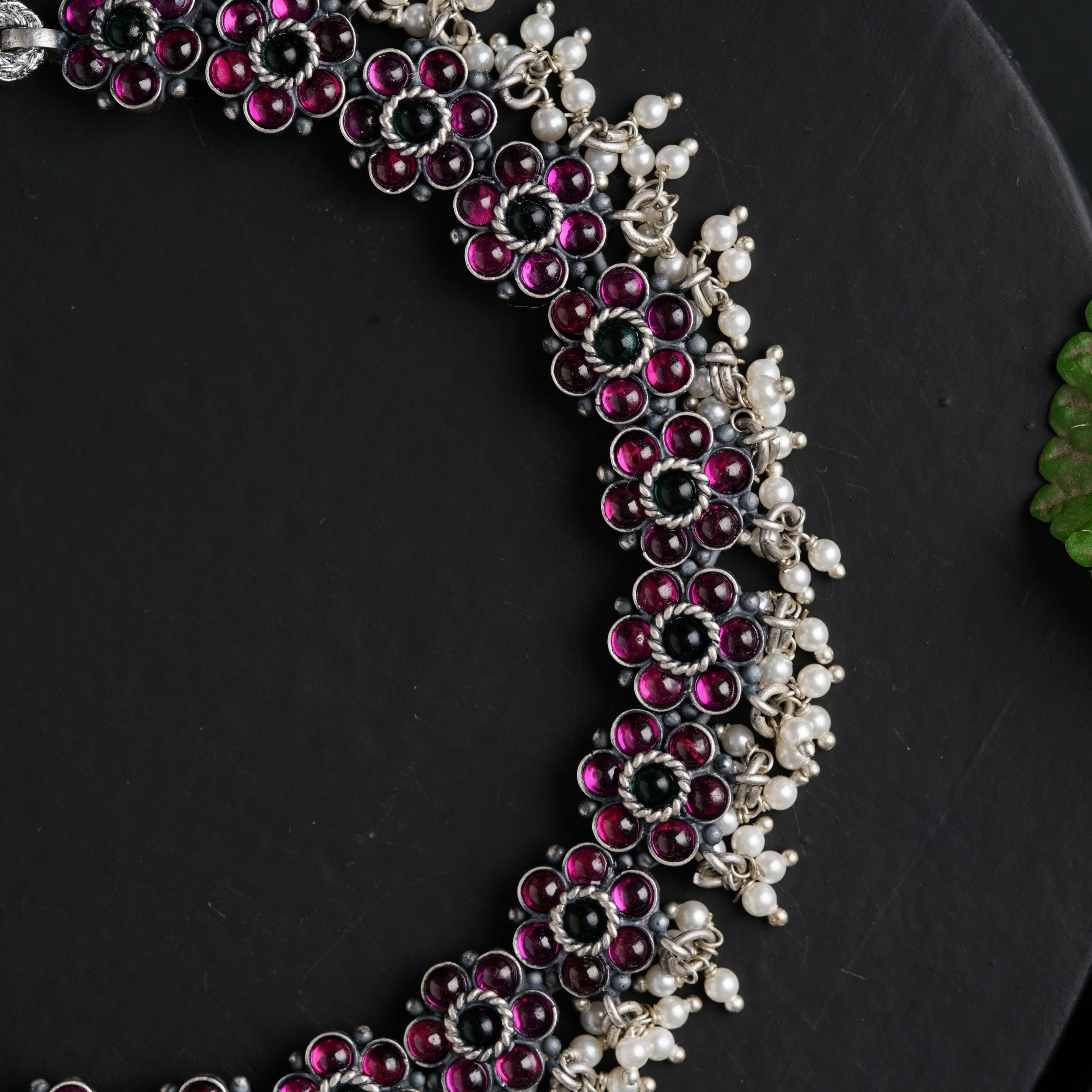a close up of a necklace on a plate