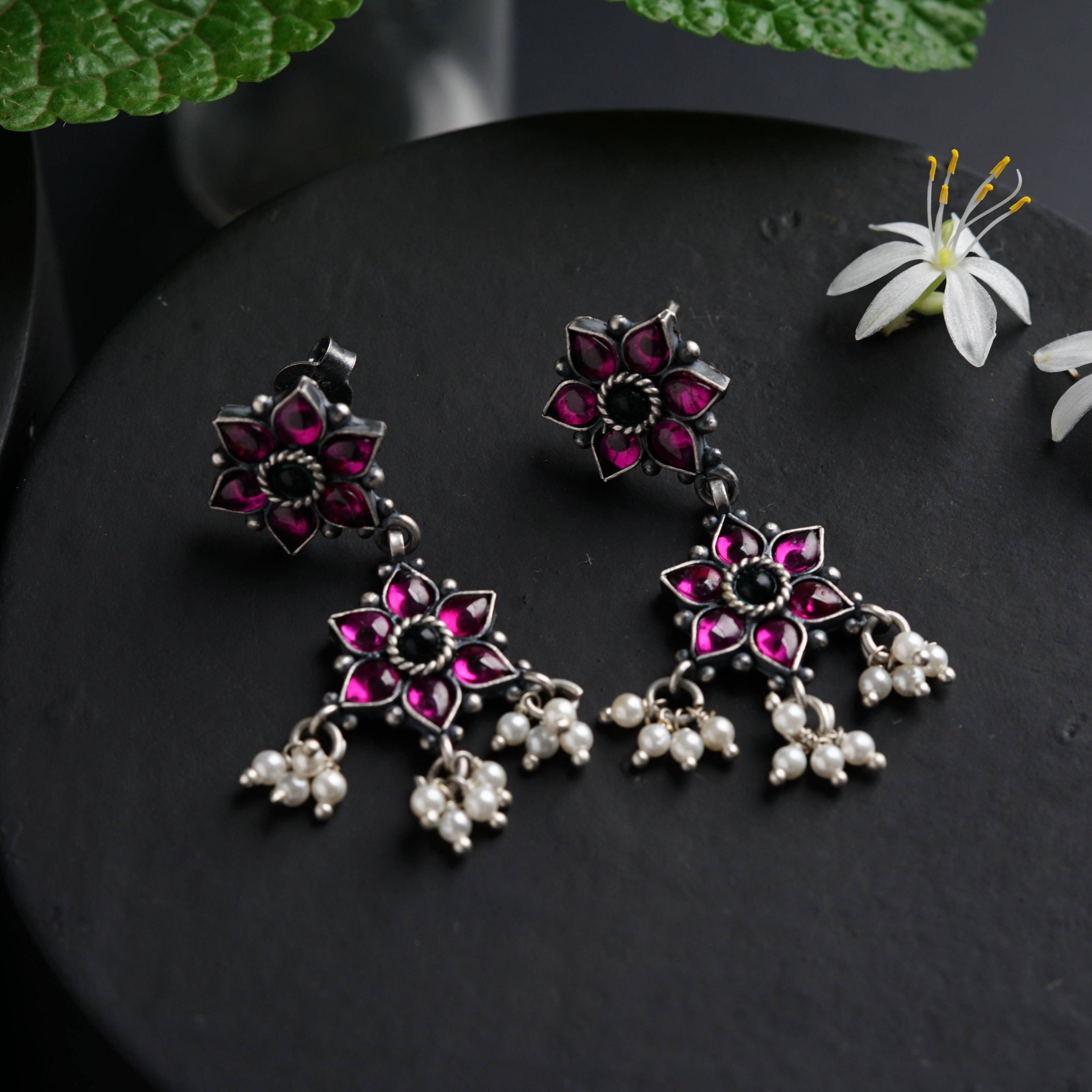 a close up of a pair of earrings on a table