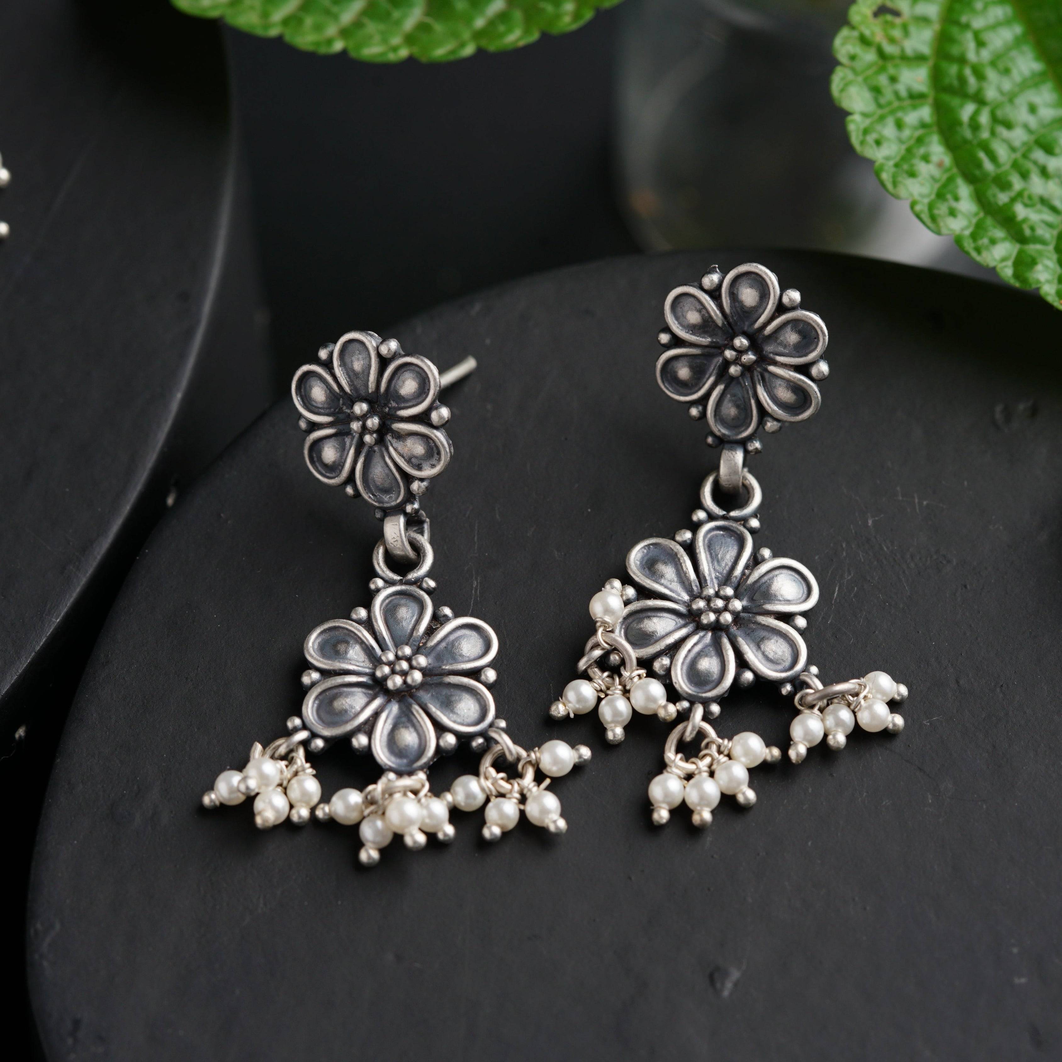 a pair of earrings sitting on top of a table