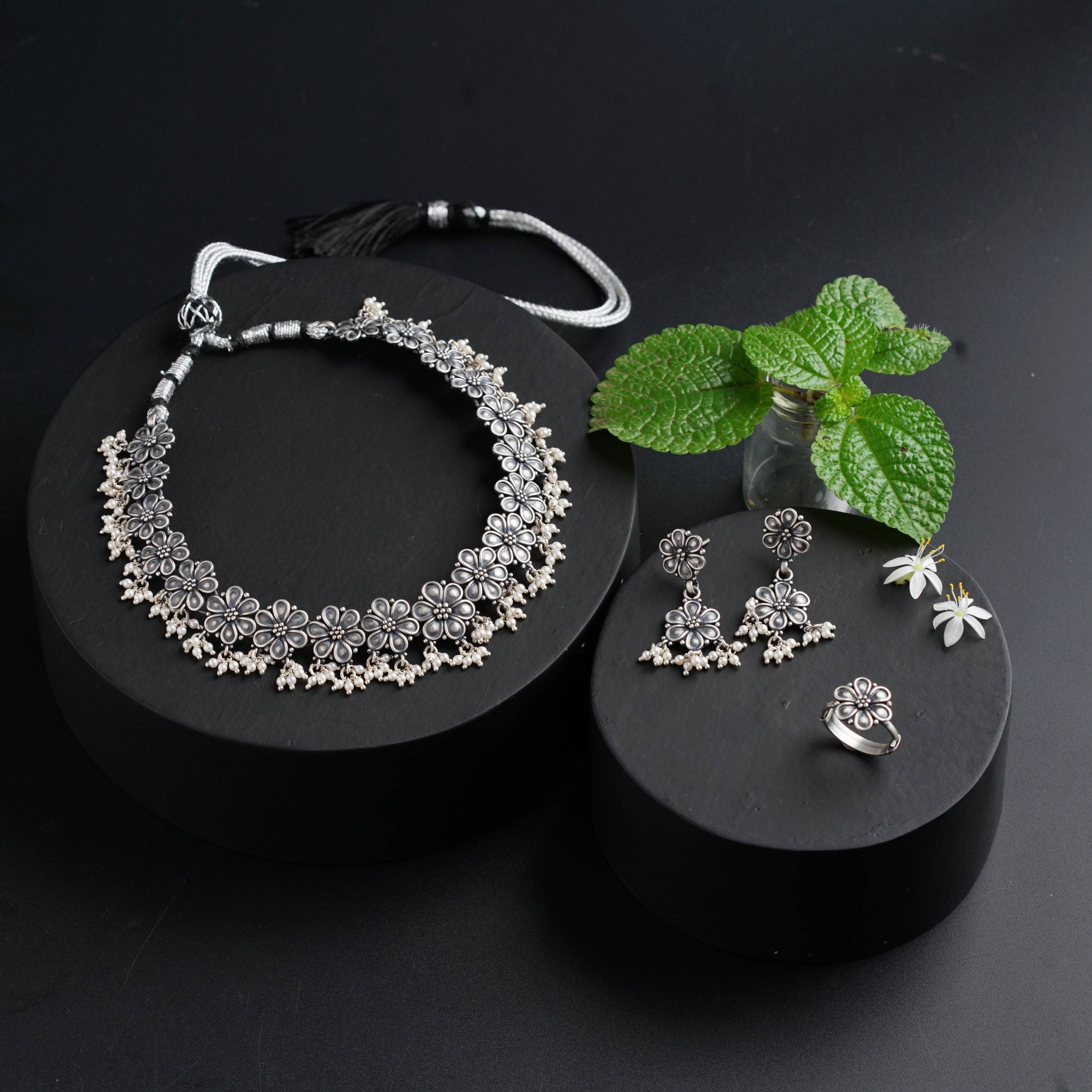 a black box with a necklace and earrings on it