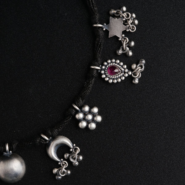 a close up of a necklace on a black surface
