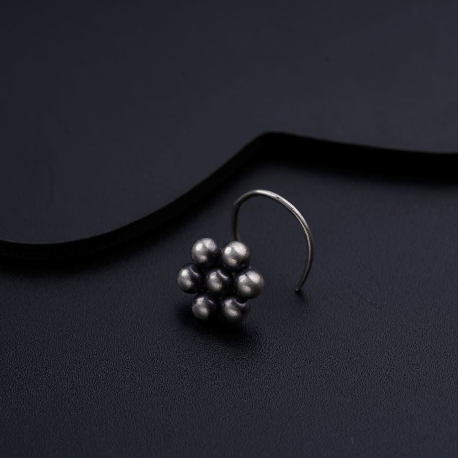 a close up of a pair of earrings on a black surface