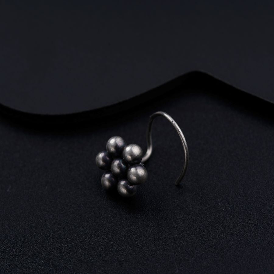 a close up of a metal object on a black surface