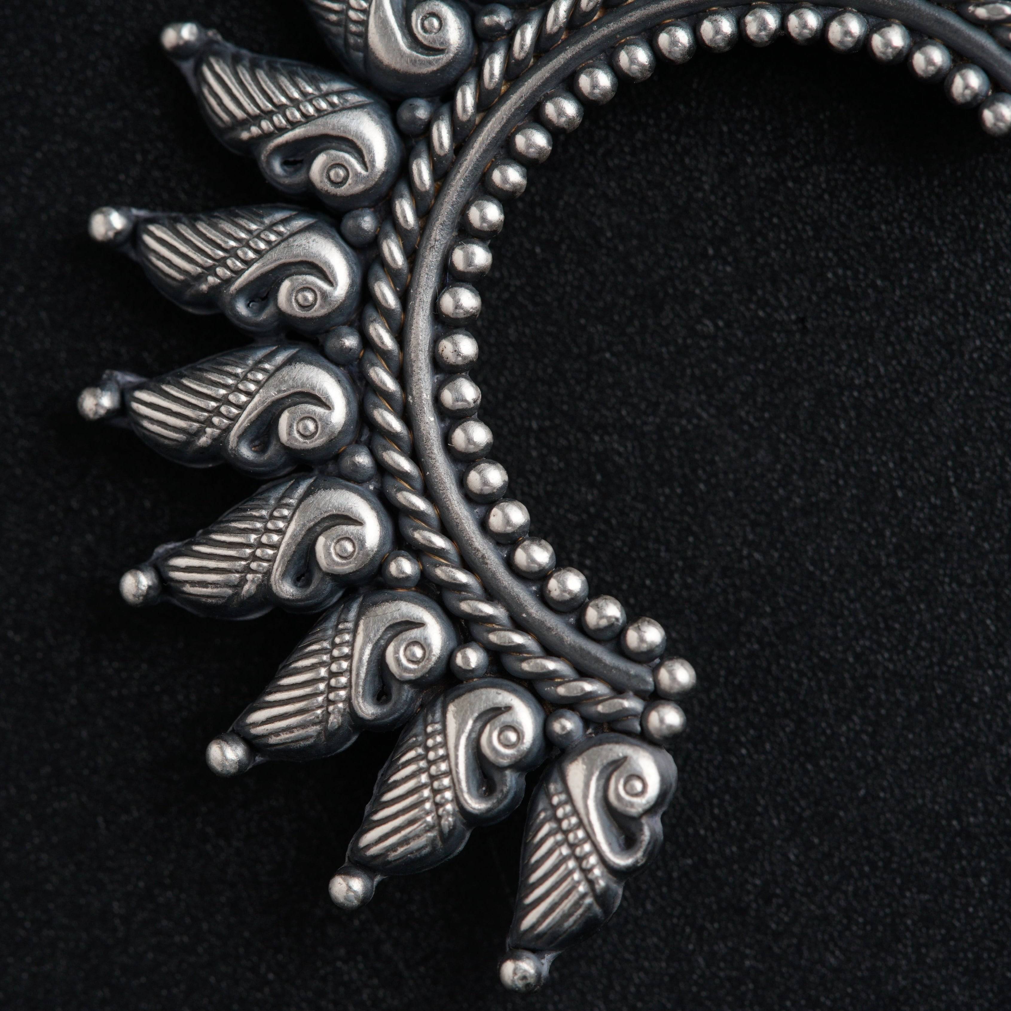 a close up of a metal object on a black surface