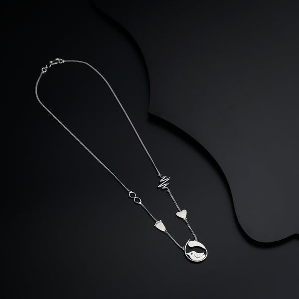 a silver necklace with a heart and two hearts hanging from it