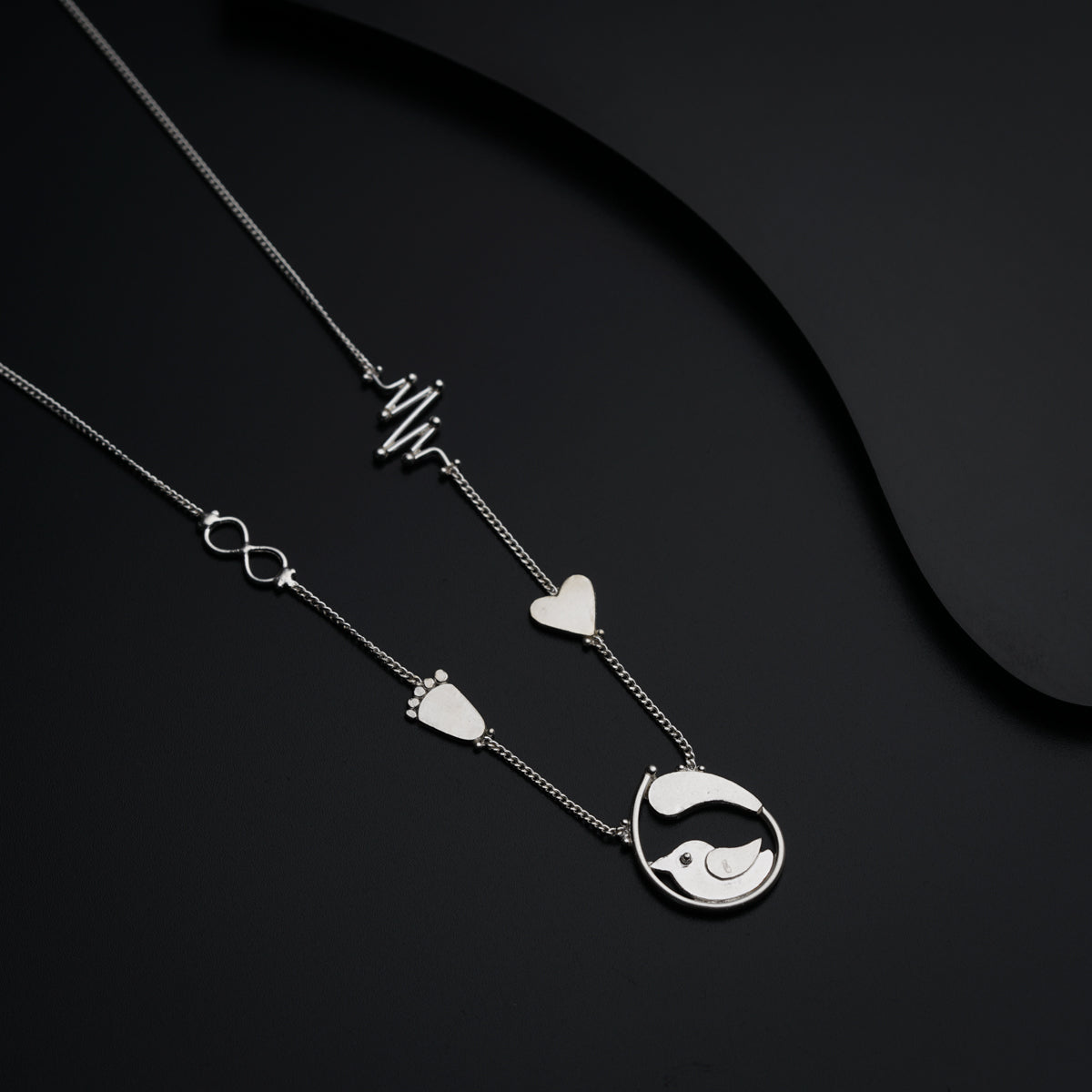 a couple of necklaces sitting on top of a table