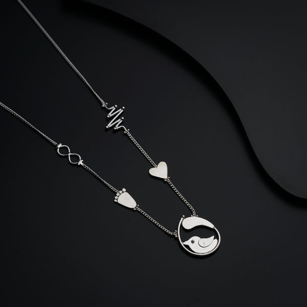 a couple of necklaces sitting on top of a table