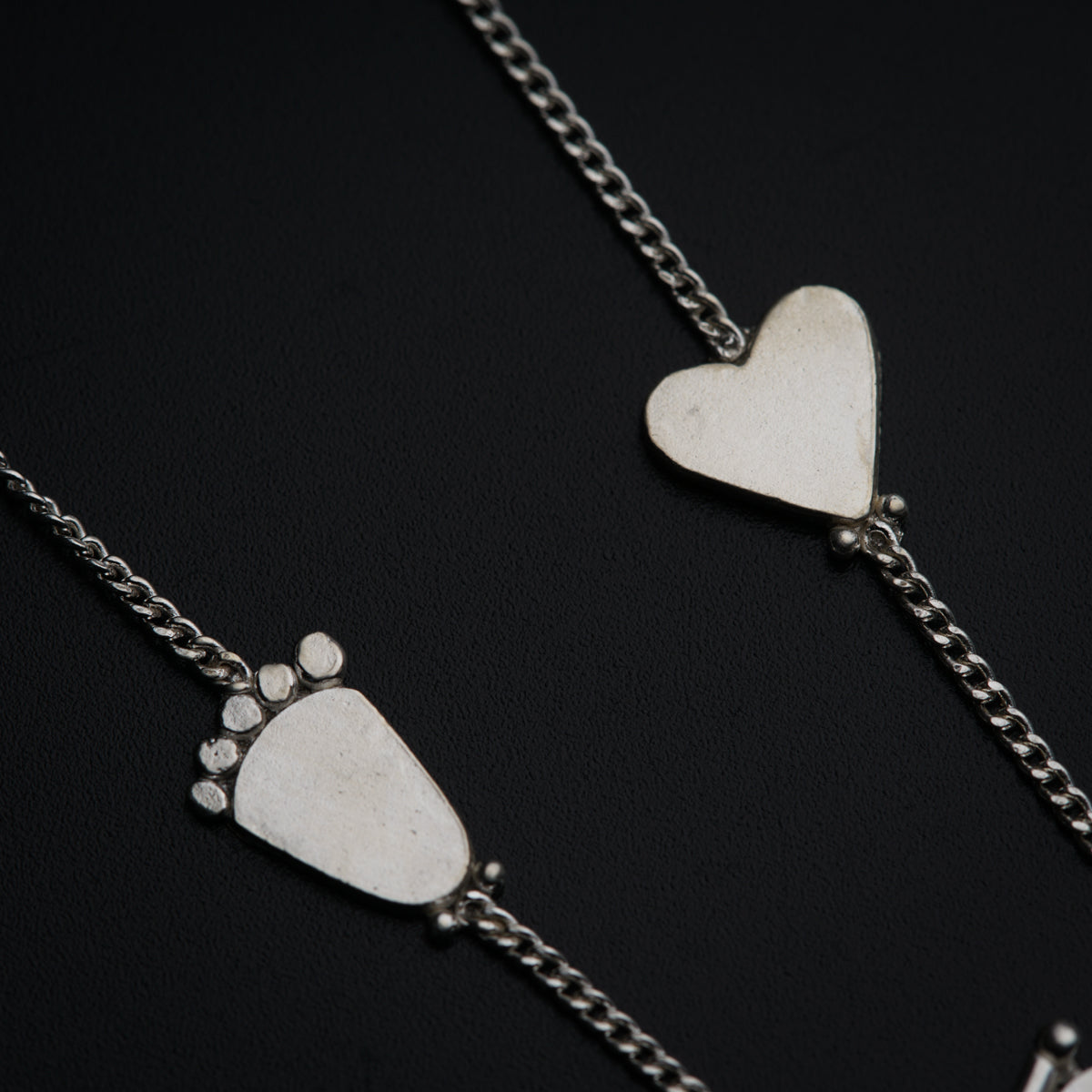 a couple of necklaces that have hearts on them