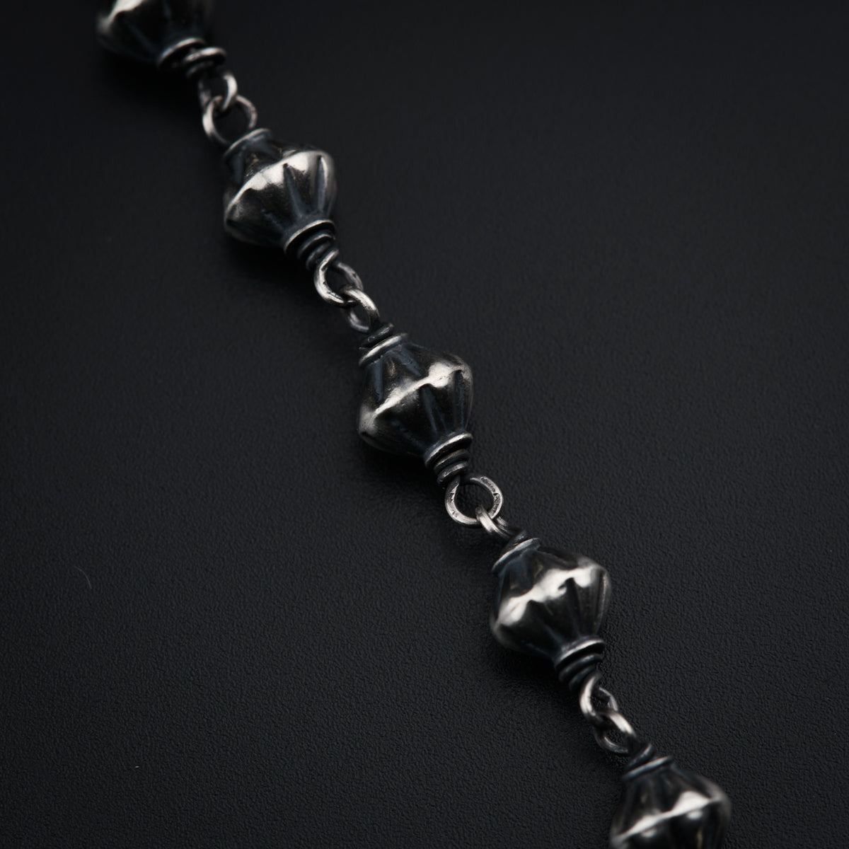 a close up of a chain on a black surface