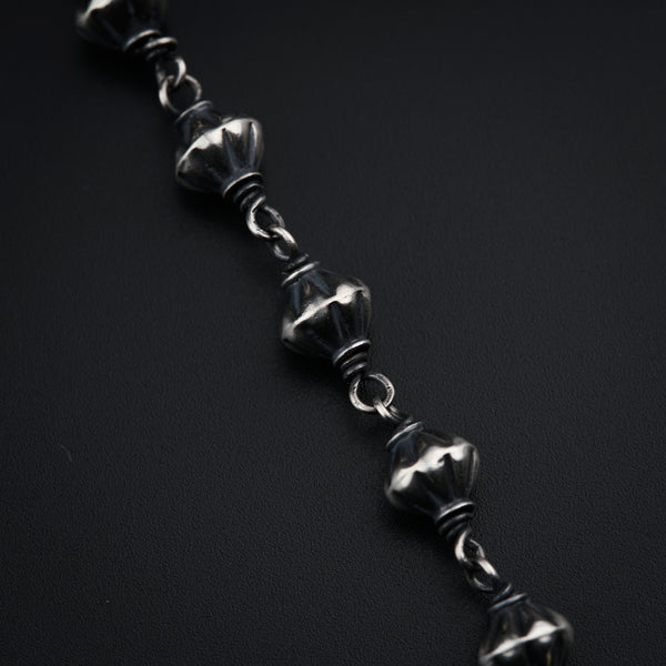 a close up of a chain on a black surface