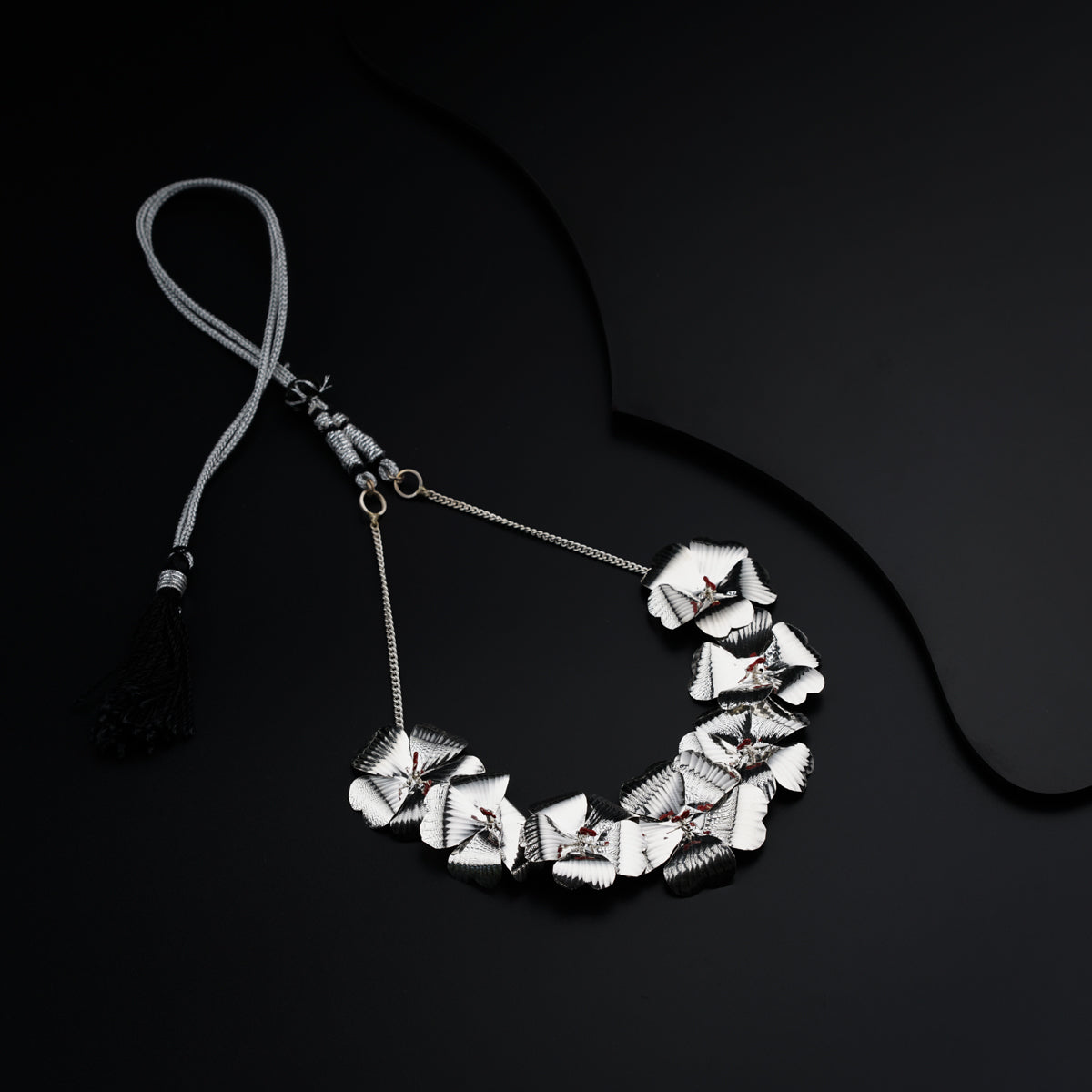 a necklace with a tassel hanging from it