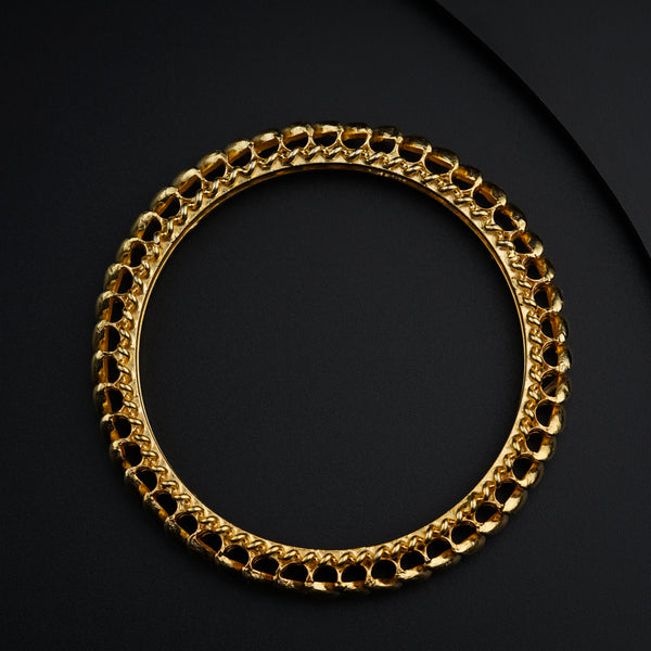 a gold chain bracelet on a black surface