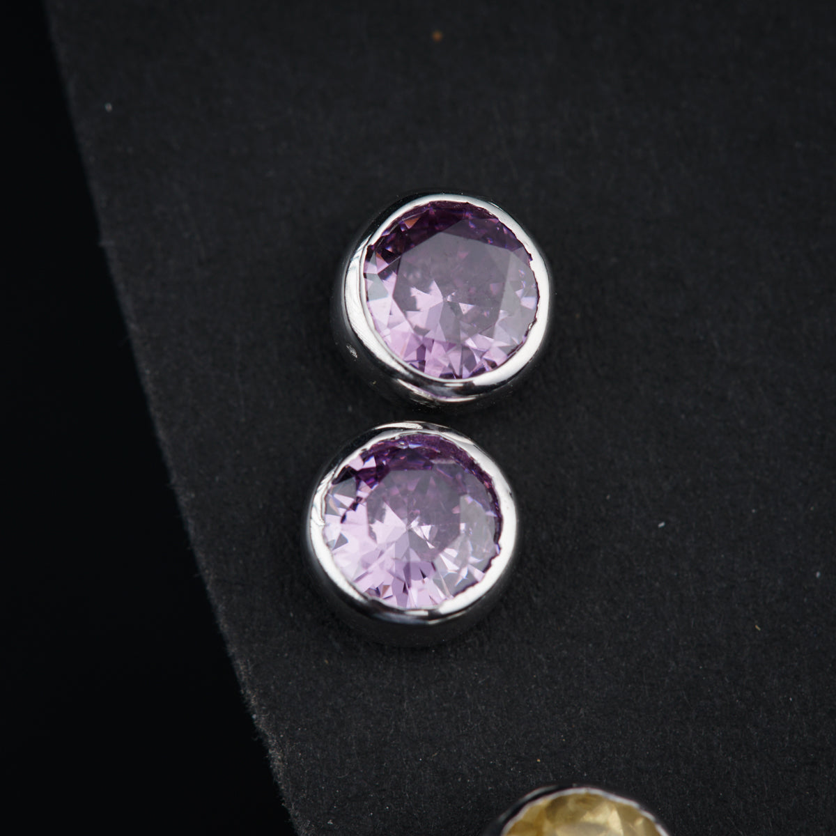 a pair of purple stones sitting on top of a black surface
