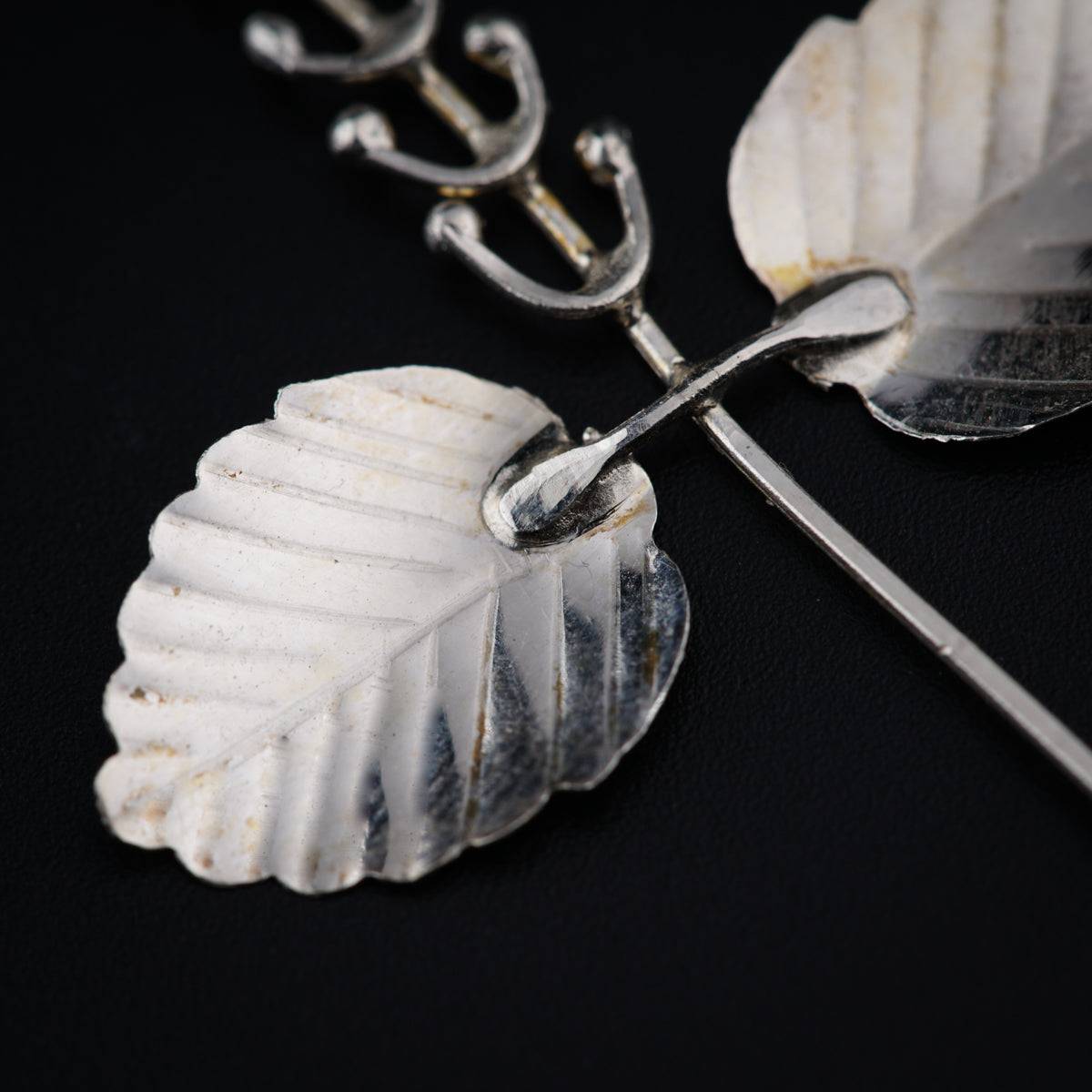 a close up of a pair of scissors and a leaf