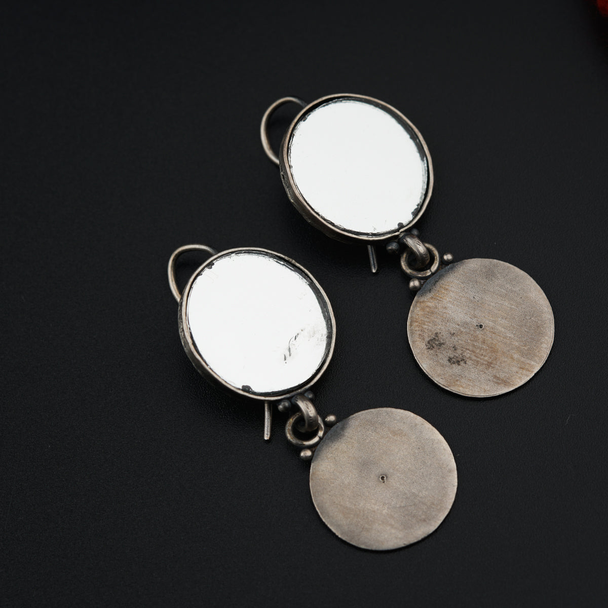 a pair of round mirrors sitting on top of a table