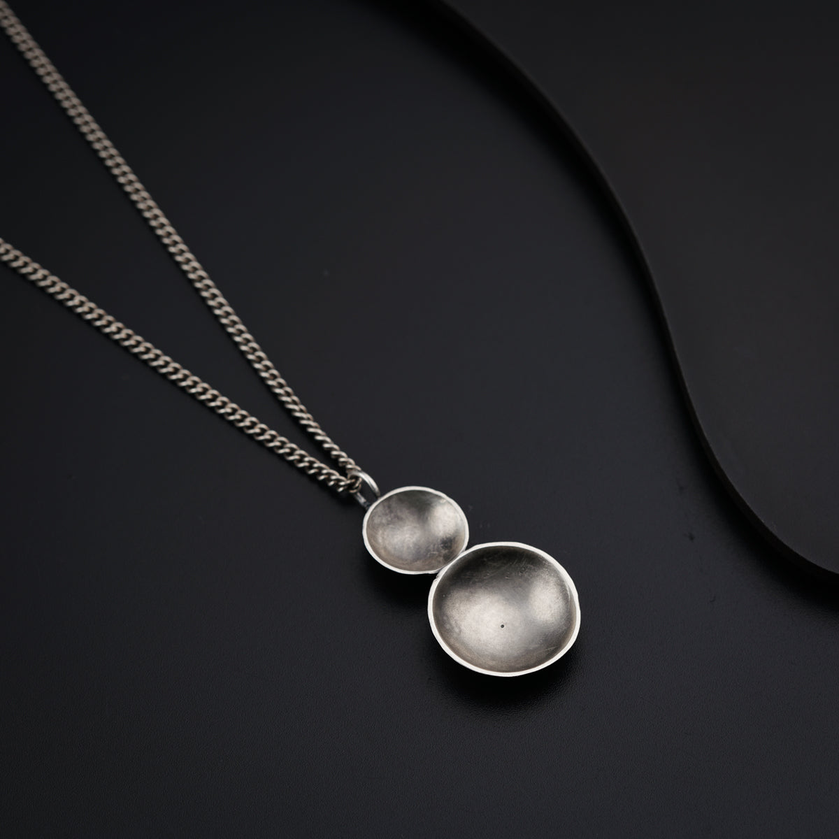 a couple of necklaces sitting on top of a table