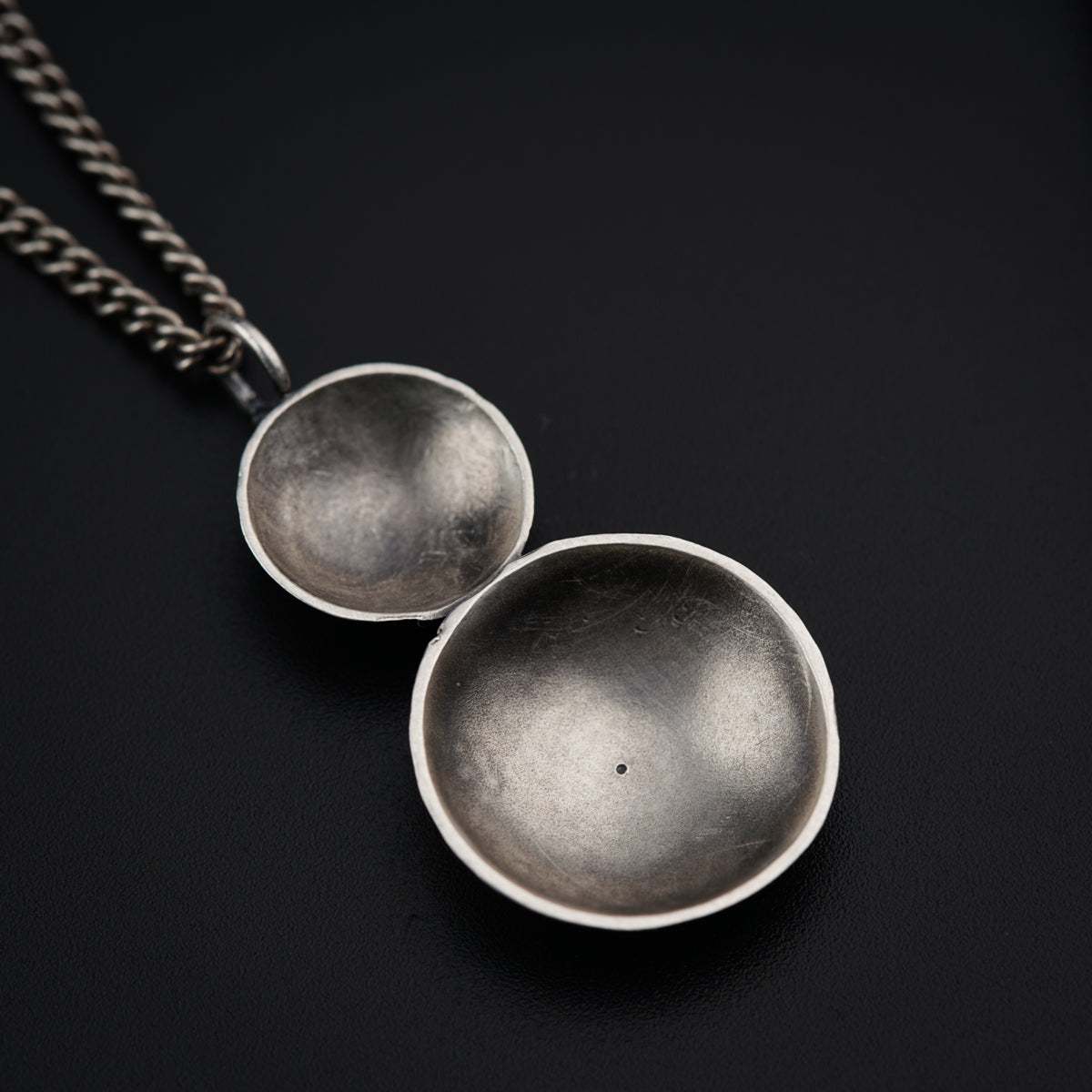 a couple of silver bowls sitting on top of a table