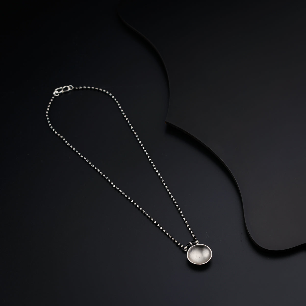 a long necklace with a pendant hanging from it