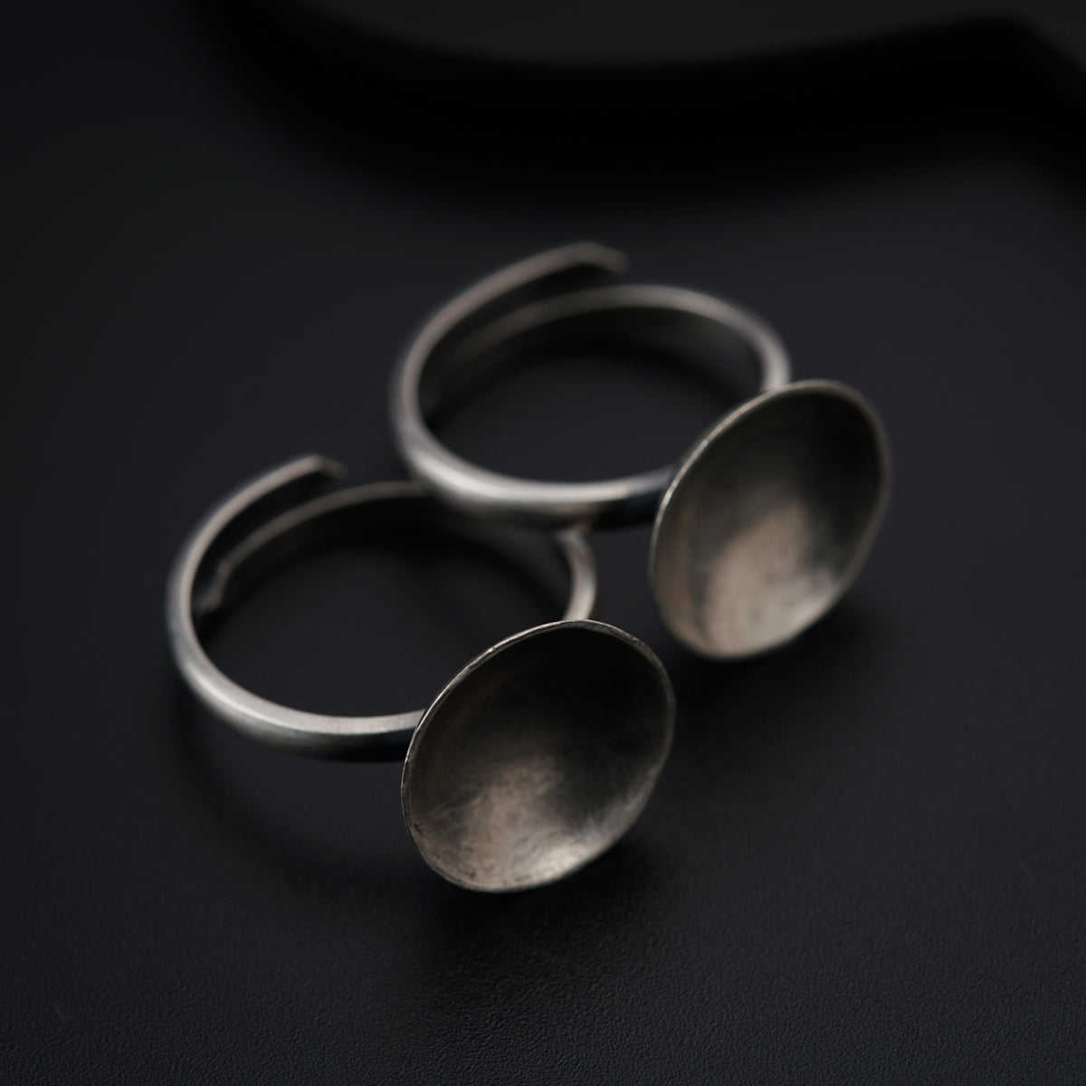 three metal spoons sitting on top of a table