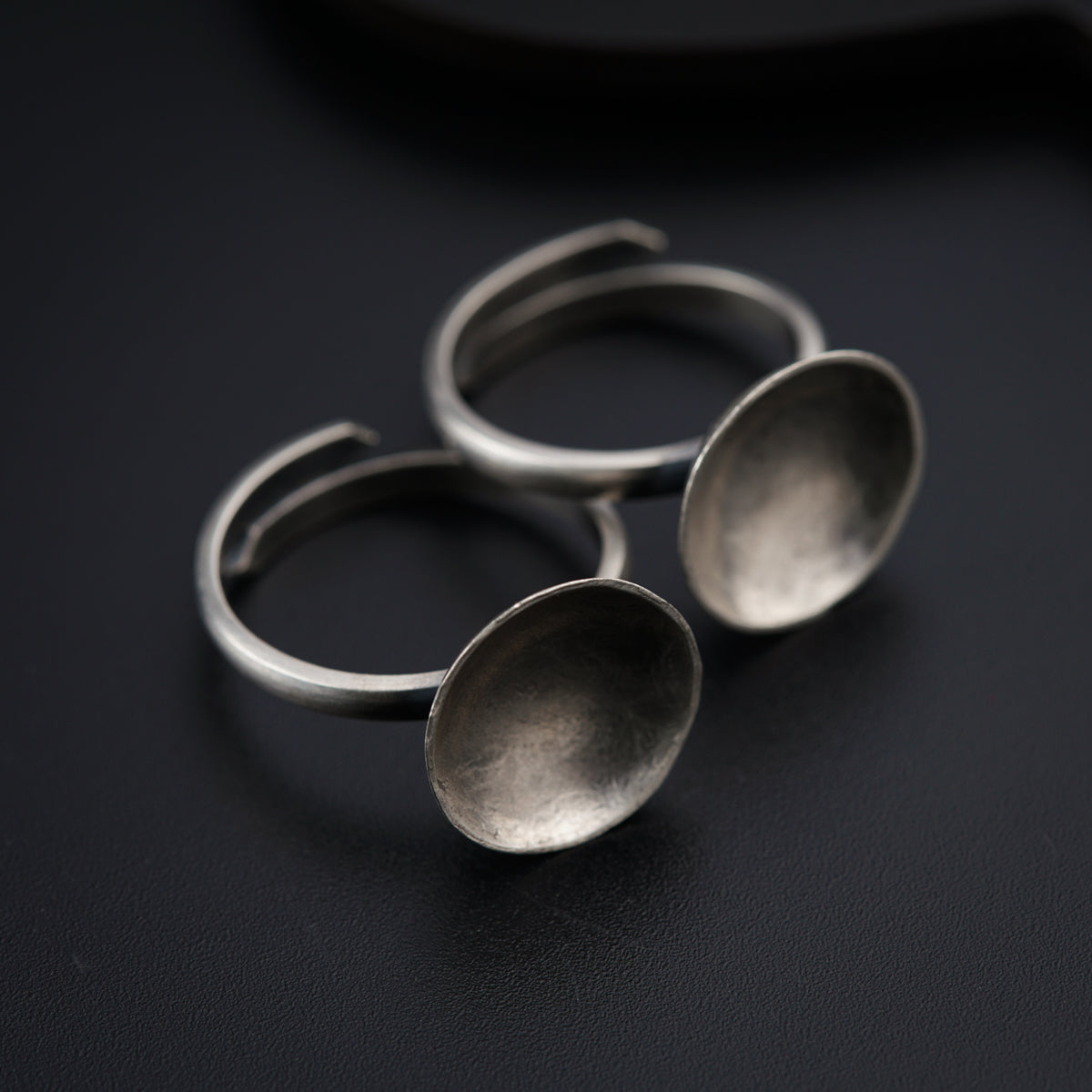 three metal spoons sitting on top of a table