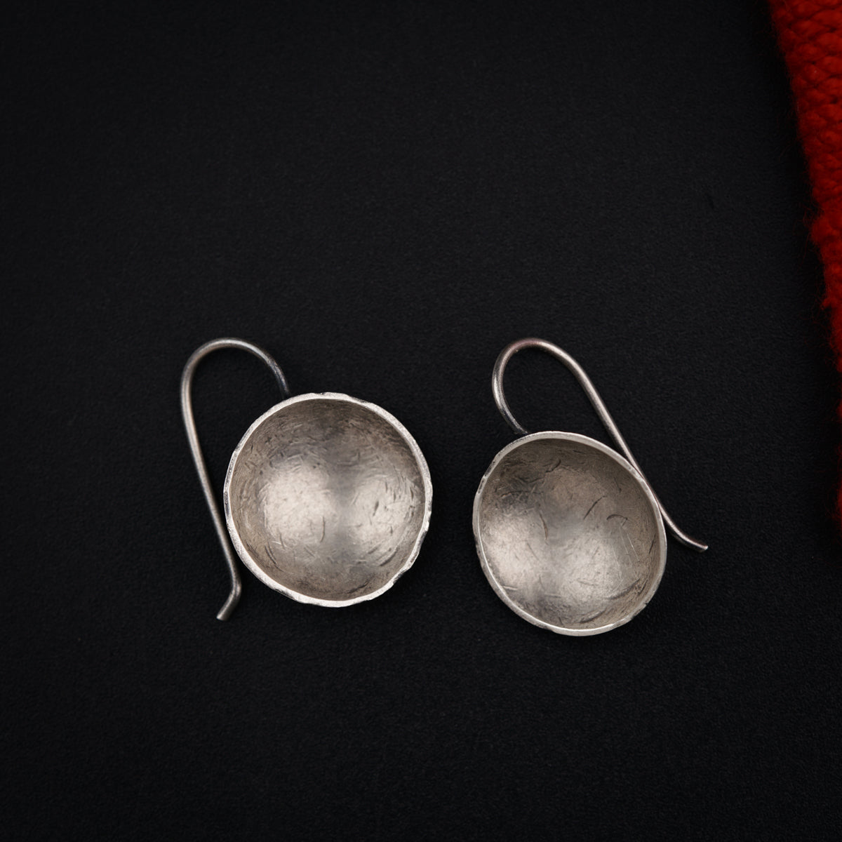 a pair of silver spoons sitting on top of a black surface