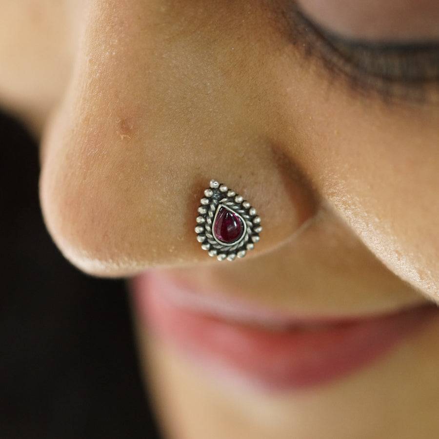 a close up of a person with a nose piercing