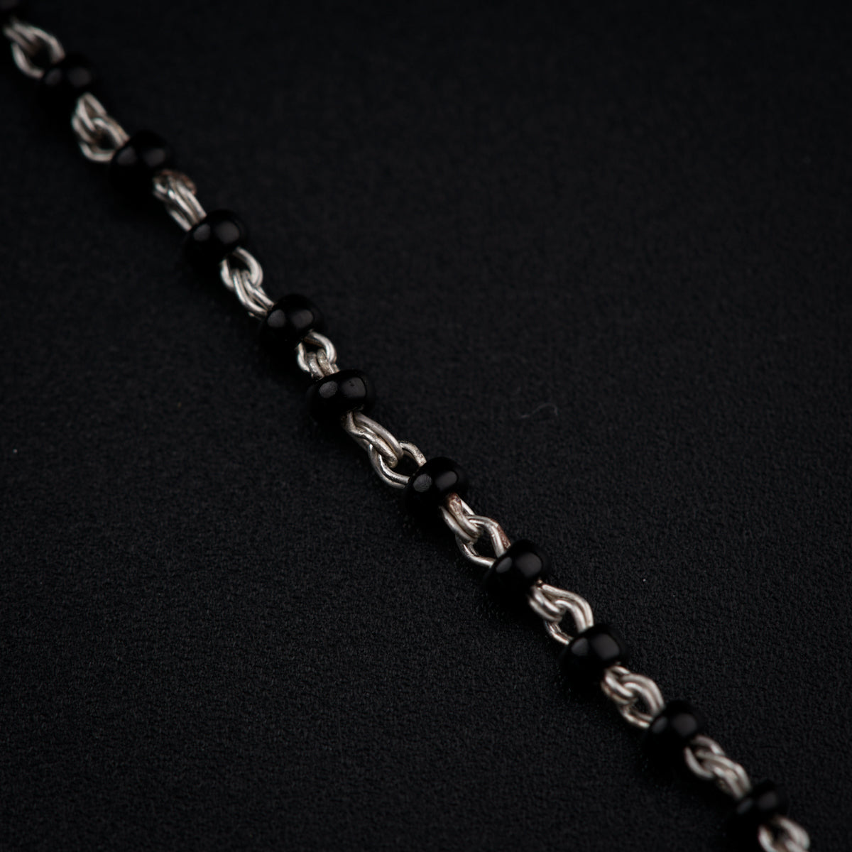 a close up of a chain on a black surface