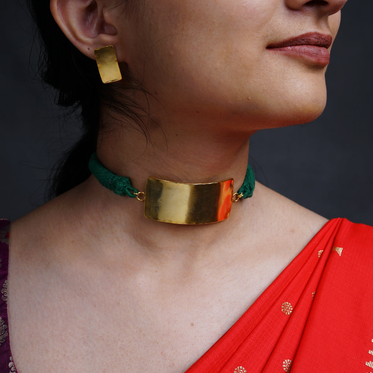 a close up of a woman wearing a necklace