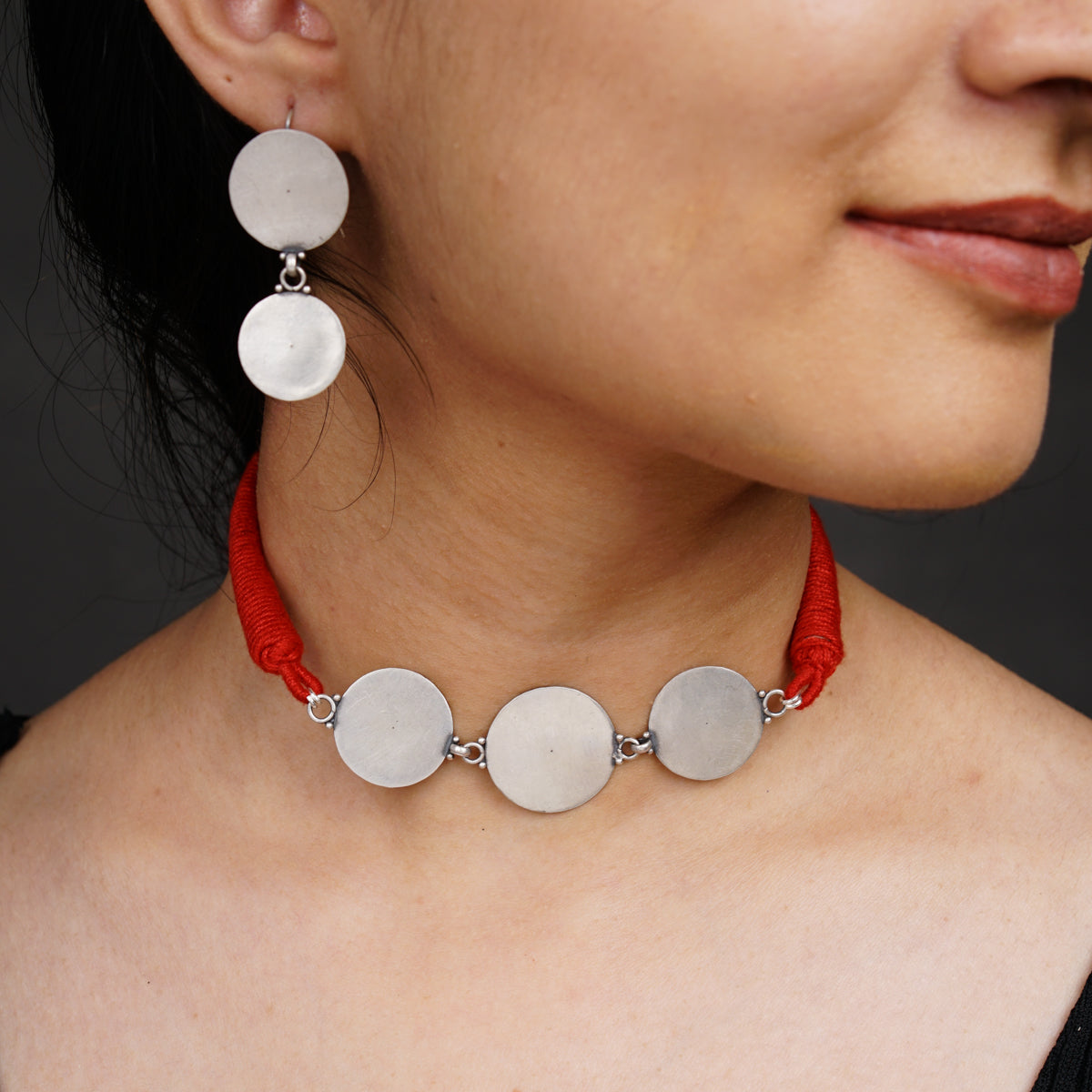 a close up of a woman wearing a necklace