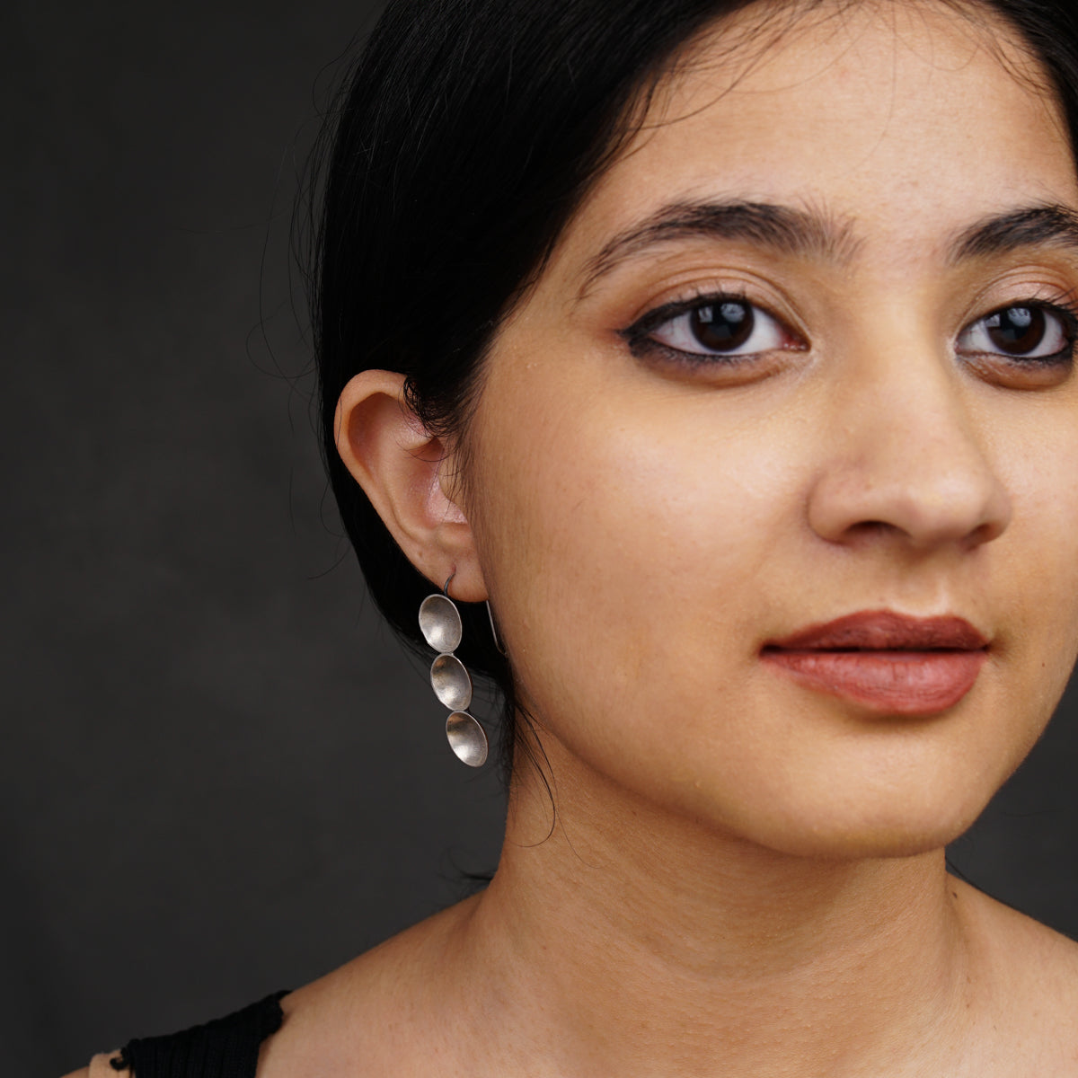 a close up of a person wearing earrings