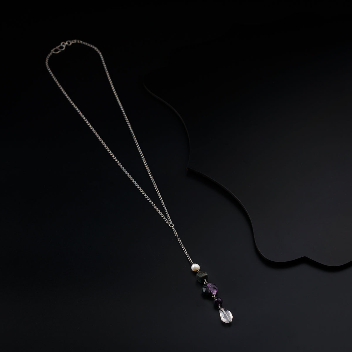 a necklace with a long chain and beads