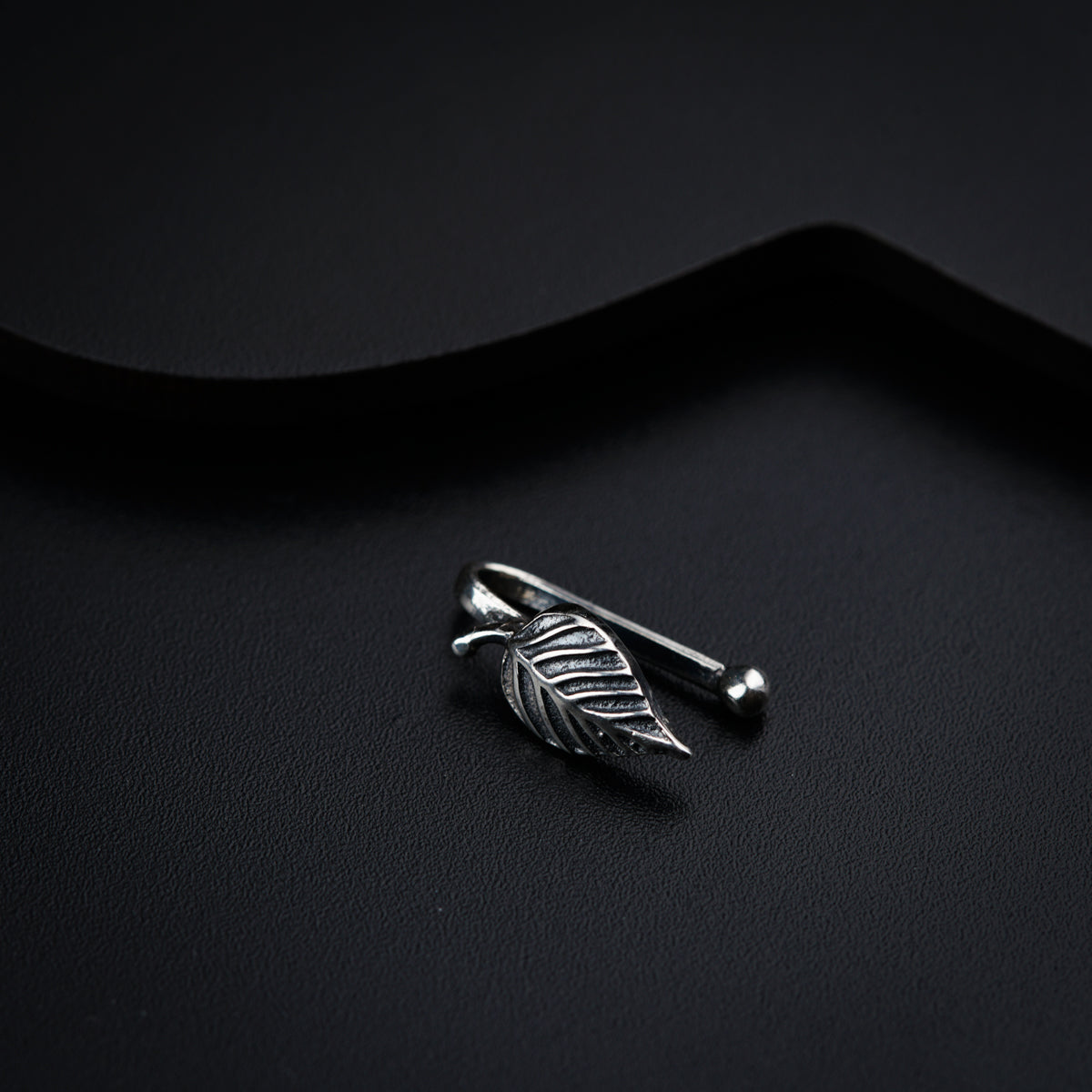 a silver ring with a leaf on it