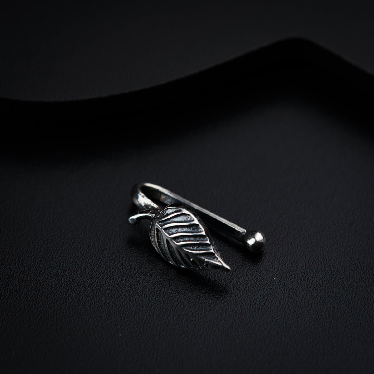 a silver ring with a leaf on it