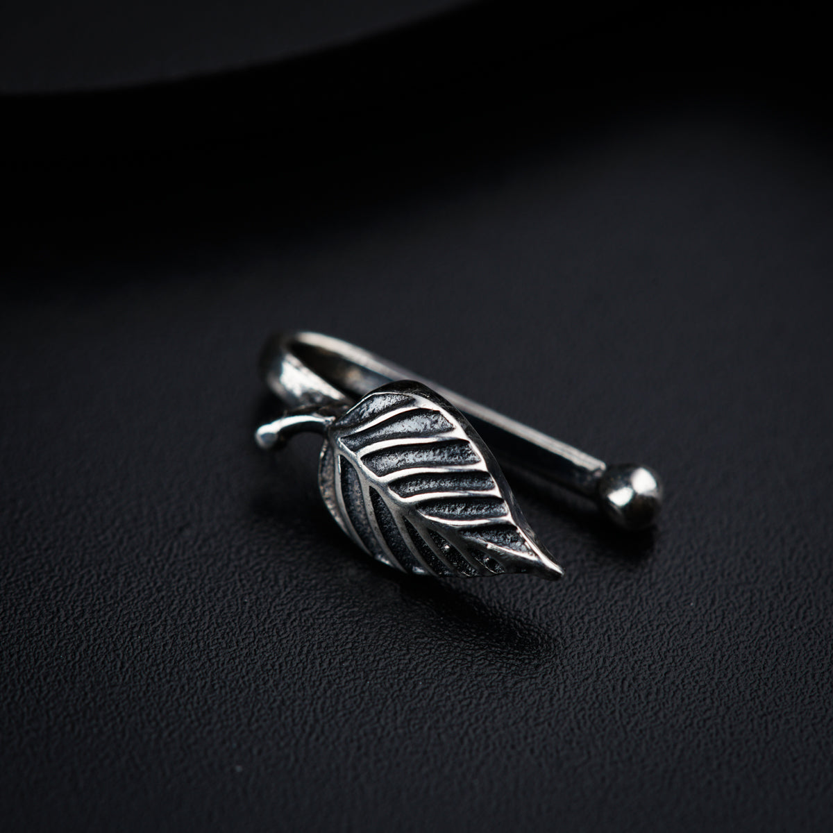 a close up of a metal object on a black surface