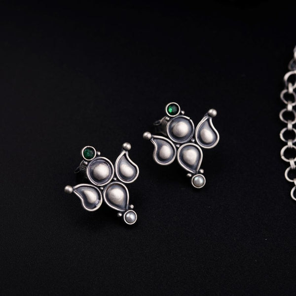 a pair of earrings sitting on top of a table