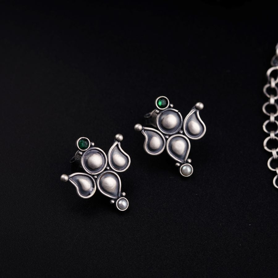 a pair of earrings sitting on top of a table