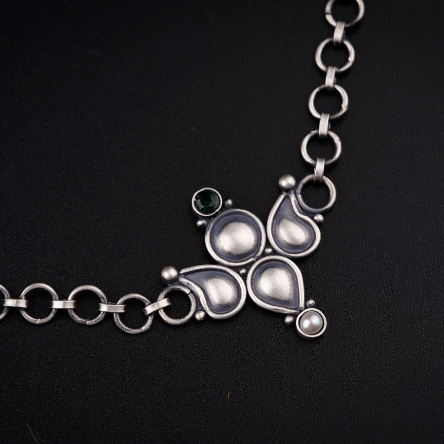 a close up of a necklace on a black surface